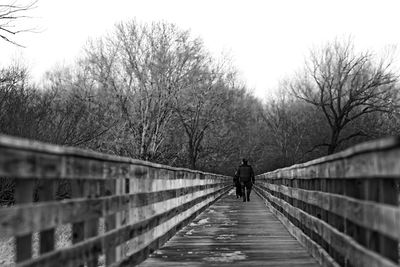 Rear view of woman walking on road