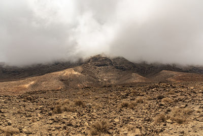 Scenic view of arid landscape against sky