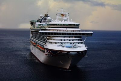 Ship sailing in sea against sky