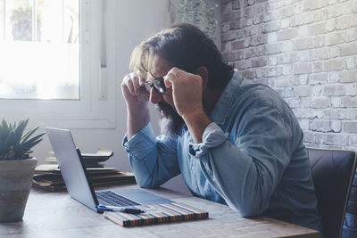 Young man using laptop at office