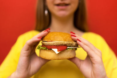 Close-up of hand holding burger