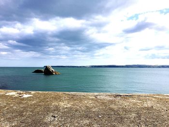 Scenic view of sea against cloudy sky