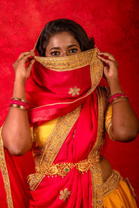 Portrait of a teenage girl wearing red mask