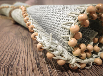 Close-up of folded place mat on wooden table