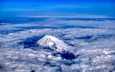 Aerial view of snowcapped mountain against sky