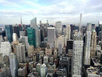 Aerial view of modern buildings in city against sky