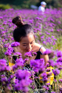 Woman standing on purple flowering plants