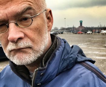 Close-up portrait of man wearing eyeglasses in city