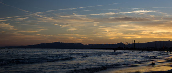 Scenic view of beach against sky during sunset