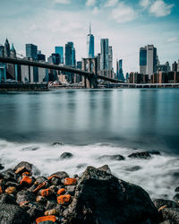 Scenic view of sea by buildings against sky