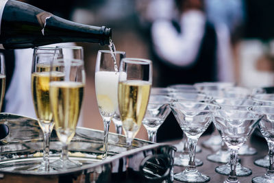 Wine pouring in glasses on table in restaurant