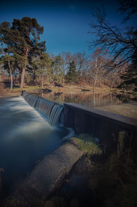 View of dam by river against sky