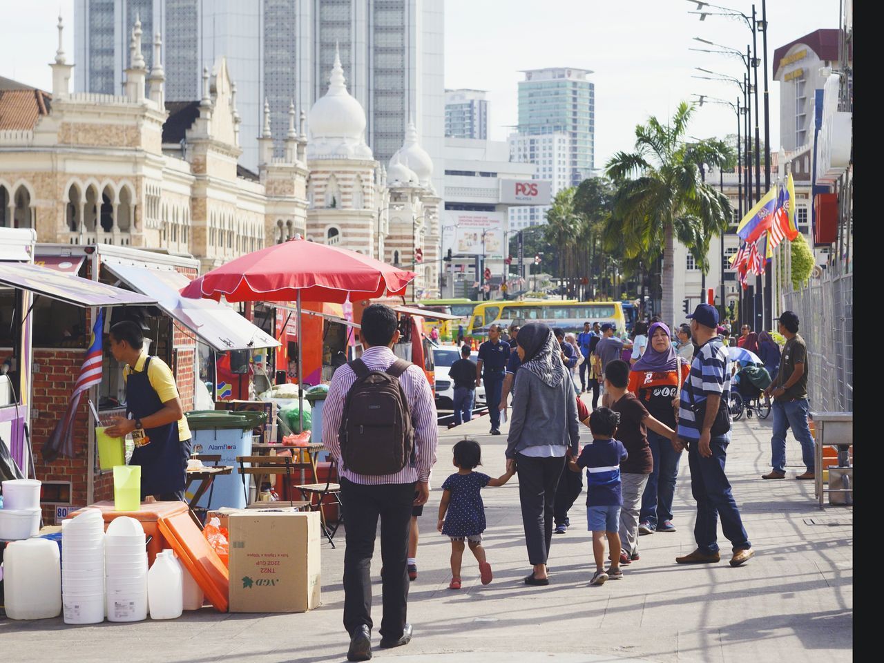 PEOPLE WALKING ON STREET AGAINST BUILDINGS