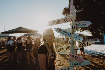 Rear view of woman with text against clear sky