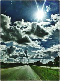 Scenic view of grassy field against sky