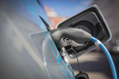 Close up of electric car charging at station