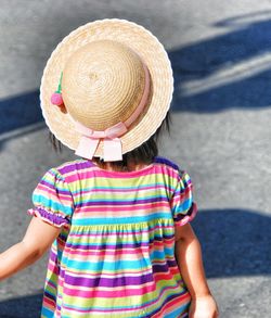 Midsection of child standing by hat