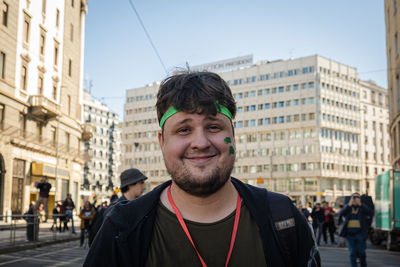 Portrait of smiling young man in city