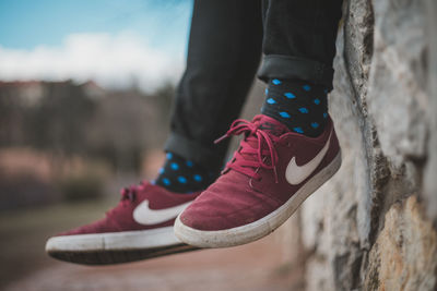 Low section of person wearing shoes standing outdoors