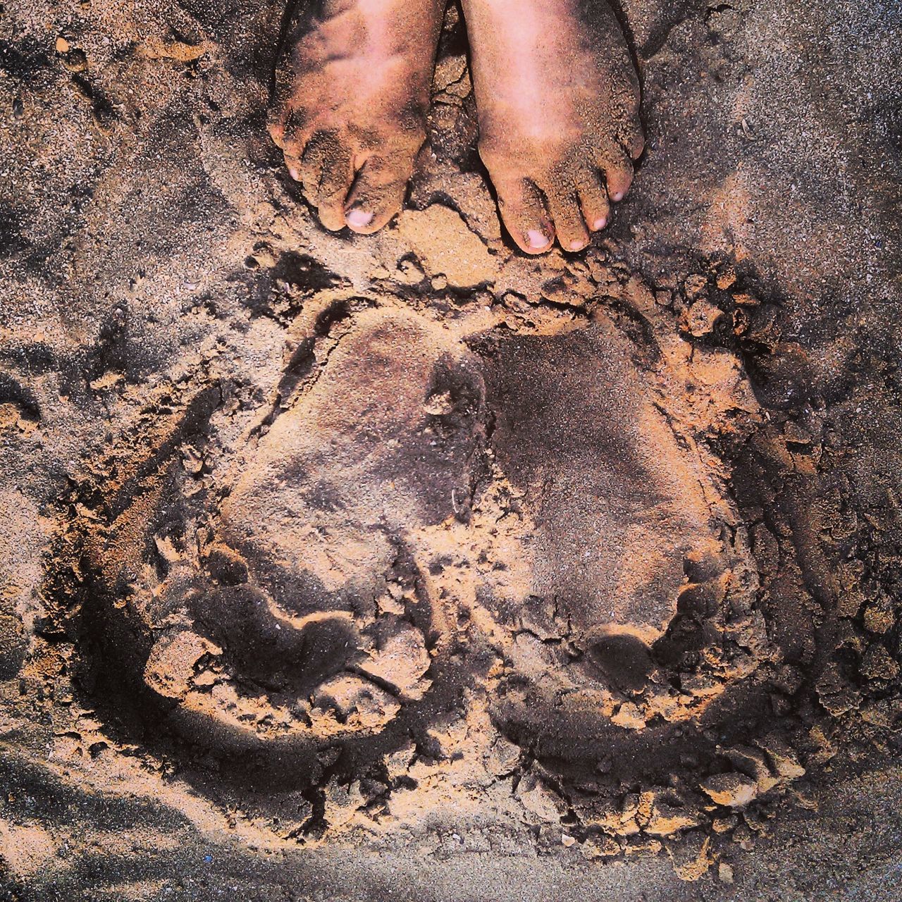 sand, beach, high angle view, low section, person, lifestyles, part of, textured, full frame, close-up, outdoors, pattern, leisure activity, sunlight, footprint, backgrounds, day