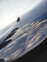 Aerial view of aircraft wing against sky