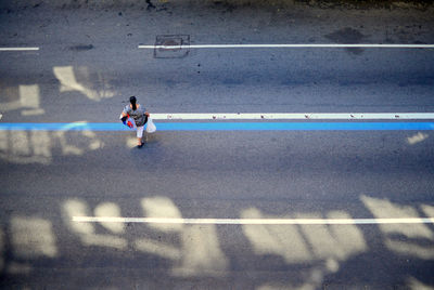 High angle view of woman running on road