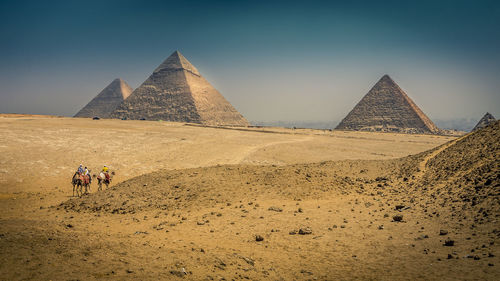 Scenic view of pyramids against clear sky