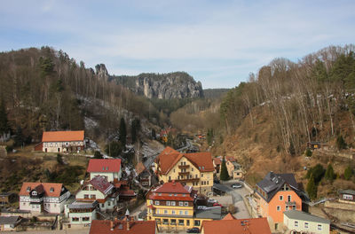 High angle view of buildings in town against sky