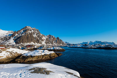 Scenic view of snowcapped mountains against clear blue sky