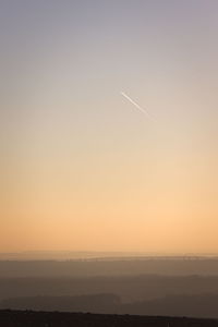 Silhouette landscape against sky during sunset