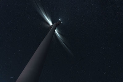 Low angle view of wind turbine against sky at night