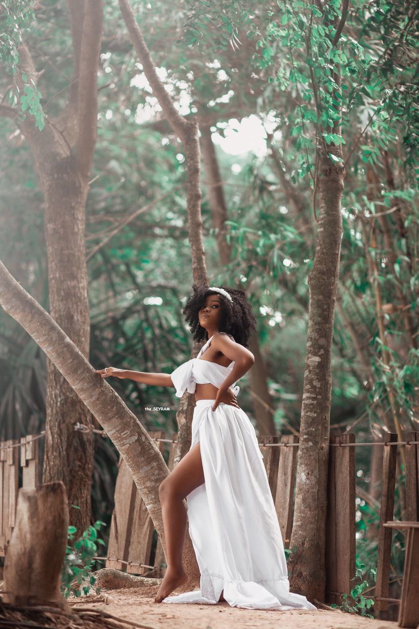 tree, women, adult, plant, one person, young adult, nature, forest, bride, fashion, dress, full length, clothing, female, land, spring, emotion, woodland, hairstyle, outdoors, lifestyles, white, tranquility, looking, beauty in nature, wedding, happiness, contemplation, standing, portrait, elegance, tranquil scene, sitting, long hair, wedding dress, relaxation, day, brown hair