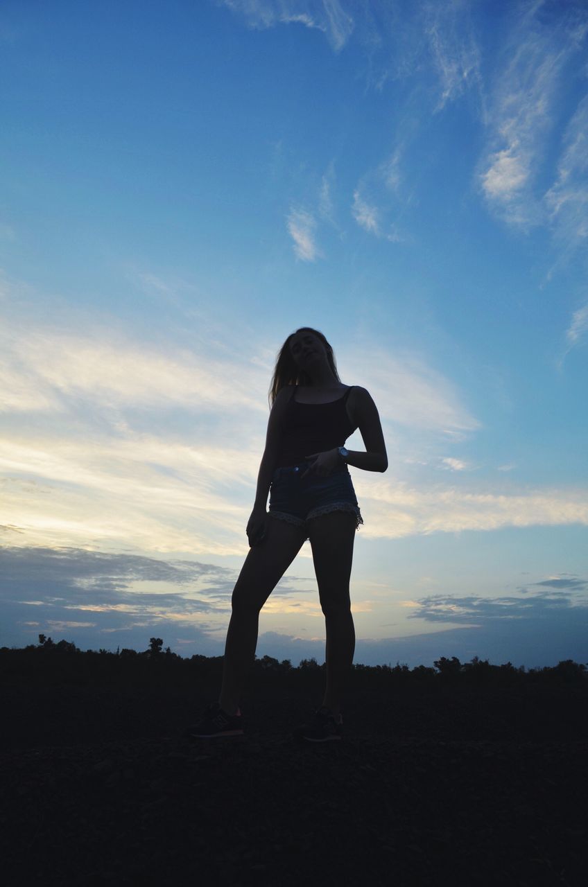 silhouette, sky, sunset, standing, full length, one person, cloud - sky, real people, women, nature, beauty in nature, lifestyles, outdoors, young adult, day, people
