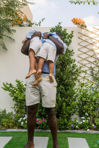 Father holding his mixed race children in his hands