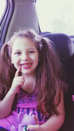 Portrait of smiling girl sitting in car