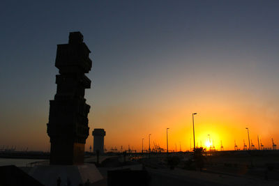 Silhouette building against sky during sunset