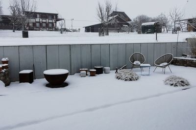 Snow covered field by building
