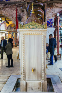 Rear view of people standing at temple