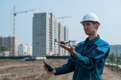 Portrait of young man standing in city