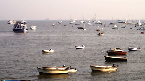 Boats moored on sea against clear sky