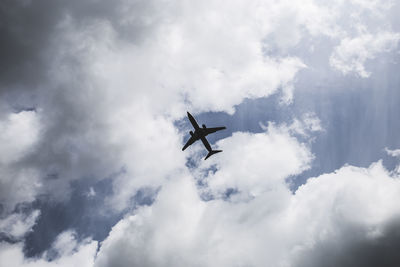 Low angle view of airplane flying in sky