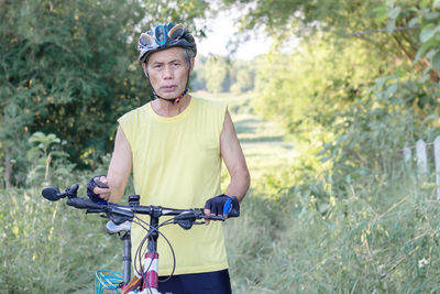 Portrait of young man riding bicycle