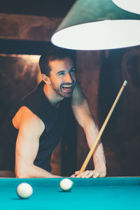 Man playing with ball on table