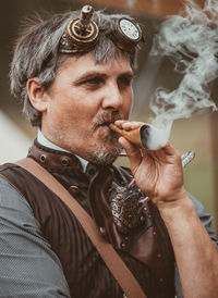 Midsection of man smoking cigarette