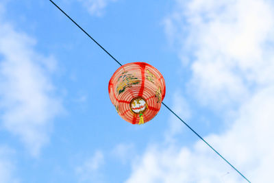 Low angle view of lantern hanging against sky