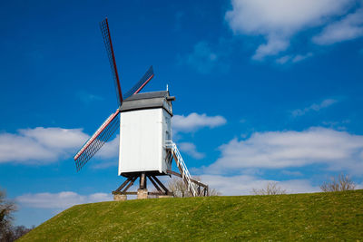 Windmill under a beautiful blue winter sky just before spring at the historical bruges town