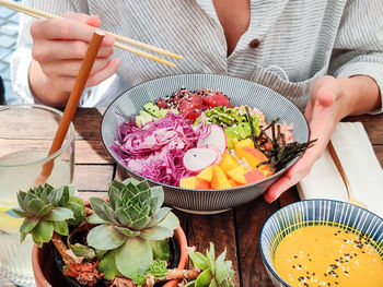 High angle view of woman preparing food on table