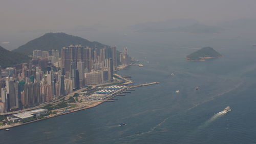 High angle view of sea and buildings against sky