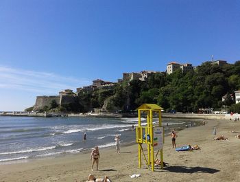Scenic view of beach against clear blue sky