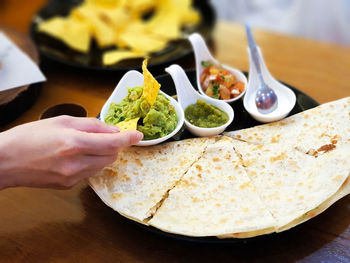 Close-up of person preparing food in plate
